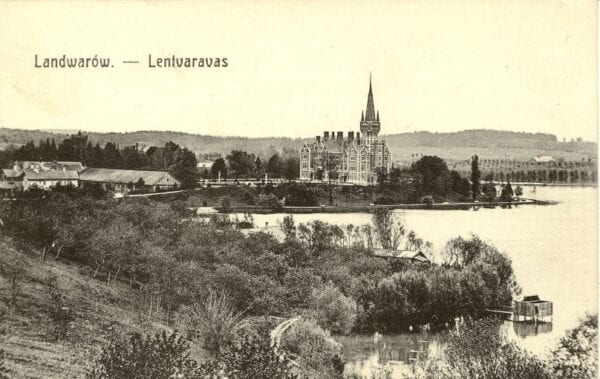 Sepia postcard showing a neo-Gothic manor with spire beside a lake, wooded shores and buildings