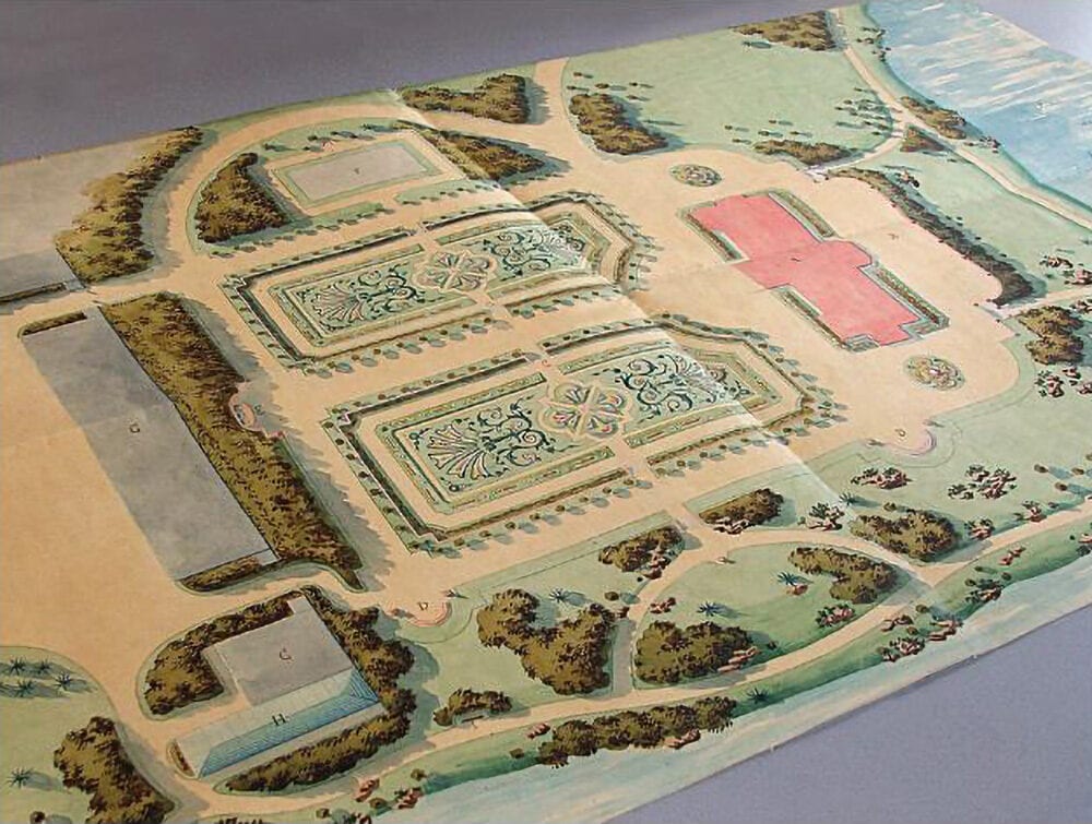 Hand-coloured landscape plan showing formal parterres, tree belts, paths, ponds and a cross-shaped building